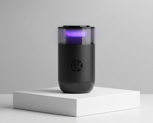 Black cylindrical device with purple light on a white platform against a gray background